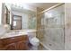 A full bathroom with a glass-enclosed shower, marble-like tile, and vanity with drawers and marble countertop at 56 Sawgrass Ct, Las Vegas, NV 89113