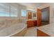 This primary bathroom features an oversized soaking tub, dual sinks, and lots of natural light at 56 Sawgrass Ct, Las Vegas, NV 89113