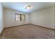 Well-lit bedroom with neutral carpet and large window is ready for your personal touches at 56 Sawgrass Ct, Las Vegas, NV 89113