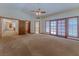 Spacious bedroom featuring vaulted ceiling, ceiling fan, and double doors to the backyard at 56 Sawgrass Ct, Las Vegas, NV 89113