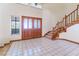 Bright entryway with wooden staircase, double doors and tiled floors at 56 Sawgrass Ct, Las Vegas, NV 89113