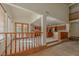 Bright foyer with wood railing overlooking an open kitchen and view to the living spaces at 56 Sawgrass Ct, Las Vegas, NV 89113