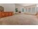 Open living room with a fireplace, bar area and large windows providing ample natural light at 56 Sawgrass Ct, Las Vegas, NV 89113