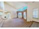 Living room with large windows, vaulted ceiling, and carpeting at 56 Sawgrass Ct, Las Vegas, NV 89113