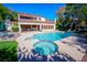 Inviting pool with a spa, surrounded by a patio and lush greenery at 56 Sawgrass Ct, Las Vegas, NV 89113