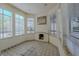 Cozy sun room with tile flooring, natural light and a quaint fireplace, great for relaxation at 56 Sawgrass Ct, Las Vegas, NV 89113