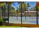 Outdoor tennis court with mature trees and manicured landscaping at 56 Sawgrass Ct, Las Vegas, NV 89113