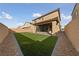 Artificial turf backyard with covered patio and rock landscaping at 595 Beverly Pine Pl, Henderson, NV 89011