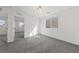 Well-lit bedroom with carpet flooring and two entry doors at 595 Beverly Pine Pl, Henderson, NV 89011