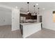 Modern kitchen with island, stainless steel appliances, and pendant lighting at 595 Beverly Pine Pl, Henderson, NV 89011