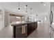 Modern kitchen island with a view into Gathering room at 595 Beverly Pine Pl, Henderson, NV 89011