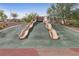 Playground featuring two wavy slides at 595 Beverly Pine Pl, Henderson, NV 89011