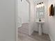 Modern powder room with pedestal sink and entry to living room at 595 Beverly Pine Pl, Henderson, NV 89011