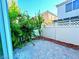 Small, paved backyard with some plants and a white fence at 6234 Hopeful Light Ave, Las Vegas, NV 89139