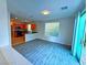 Open living area with kitchen view and sliding door to backyard at 6234 Hopeful Light Ave, Las Vegas, NV 89139