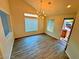 Bright living room with wood-look floors and a statement light fixture at 6234 Hopeful Light Ave, Las Vegas, NV 89139