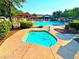 Community pool and spa with ample lounge chairs and shade structures at 6234 Hopeful Light Ave, Las Vegas, NV 89139