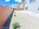 Landscaped backyard with a large concrete patio at 6335 Rock Stream Ln, Las Vegas, NV 89141