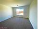 Spacious carpeted bedroom with large window at 6335 Rock Stream Ln, Las Vegas, NV 89141