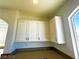 White upper kitchen cabinets with corner shelving at 6335 Rock Stream Ln, Las Vegas, NV 89141