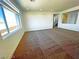 Bright living room with large windows and carpeted floors at 6335 Rock Stream Ln, Las Vegas, NV 89141