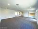 Spacious living room with neutral carpeting and recessed lighting at 6335 Rock Stream Ln, Las Vegas, NV 89141