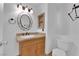 Bathroom boasts a vanity with a granite countertop and an oval mirror at 6458 Bluehurst Ave, Las Vegas, NV 89156