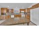 Spacious kitchen boasts wood cabinets and granite island at 6458 Bluehurst Ave, Las Vegas, NV 89156