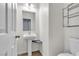 Clean and simple bathroom with pedestal sink and shelving at 6513 Heavenly Moon St, North Las Vegas, NV 89084