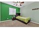 Charming bedroom with green and neutral walls, and a ceiling fan at 6513 Heavenly Moon St, North Las Vegas, NV 89084