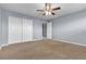 Large bedroom with gray walls and a ceiling fan at 6513 Heavenly Moon St, North Las Vegas, NV 89084