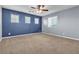 Spacious bedroom with blue and gray walls, and ceiling fan at 6513 Heavenly Moon St, North Las Vegas, NV 89084