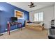 Bedroom with blue accent wall, built-in drawers, and ceiling fan at 6513 Heavenly Moon St, North Las Vegas, NV 89084