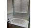 Bathroom featuring a tub, neutral tile, and natural light from the window at 658 Forest Peak St, Henderson, NV 89011