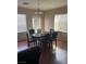 Neutral dining room featuring a wooden table, six chairs, and a modern chandelier at 658 Forest Peak St, Henderson, NV 89011