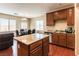 Eat-in kitchen with island, stainless appliances, wood floors, and ample counter space, perfect for cooking and entertaining at 658 Forest Peak St, Henderson, NV 89011