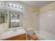 Bathroom with single sink vanity, bathtub, and tiled walls at 6750 Del Rey Ave # 262, Las Vegas, NV 89146