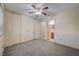 Bedroom featuring ceiling fan, ample closet space, and access to bathroom at 6750 Del Rey Ave # 262, Las Vegas, NV 89146