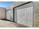 Attached garage with white roll-up door at 6750 Del Rey Ave # 262, Las Vegas, NV 89146