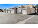 Exterior view of attached garages with white doors at 6750 Del Rey Ave # 262, Las Vegas, NV 89146