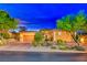 Beautiful desert landscaping surrounds this single-story home with a 2 car garage at 70 Portezza Dr, Henderson, NV 89011