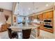 Large kitchen with a circular granite island and stainless steel appliances at 70 Portezza Dr, Henderson, NV 89011