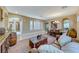 Open living room and dining area with leather furniture and wood accents at 70 Portezza Dr, Henderson, NV 89011