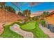 Landscaped backyard with private putting green at 70 Portezza Dr, Henderson, NV 89011