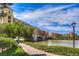 Scenic waterfront pathway with bridge and charming community buildings at 70 Portezza Dr, Henderson, NV 89011