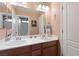 Double vanity bathroom with modern fixtures and a mirror at 7306 Puckershire St, Las Vegas, NV 89166