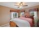 Well-lit bedroom with wooden bed frame and window coverings at 7306 Puckershire St, Las Vegas, NV 89166