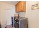 Convenient laundry room with washer, dryer, and cabinets at 7306 Puckershire St, Las Vegas, NV 89166