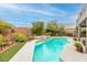 Inviting pool and spa, surrounded by lush landscaping at 7306 Puckershire St, Las Vegas, NV 89166