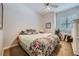 Guest bedroom with floral bedding and a ceiling fan at 7456 Ute Meadows Cir, Las Vegas, NV 89129